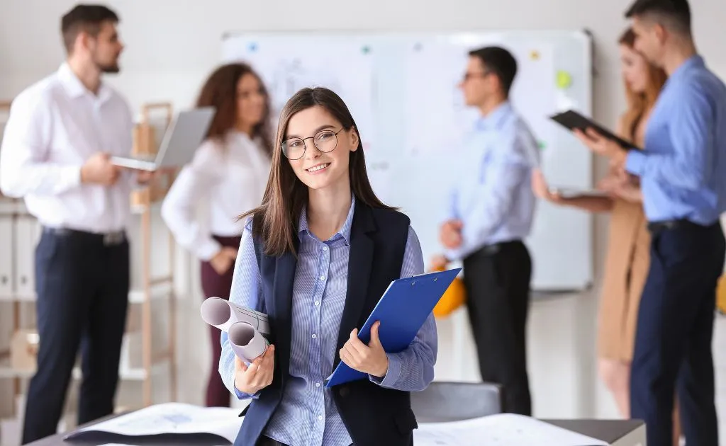 Giovane professionista con cartella e documenti in un ambiente lavorativo, ideale per i corsi Preply Business dedicati alle aziende